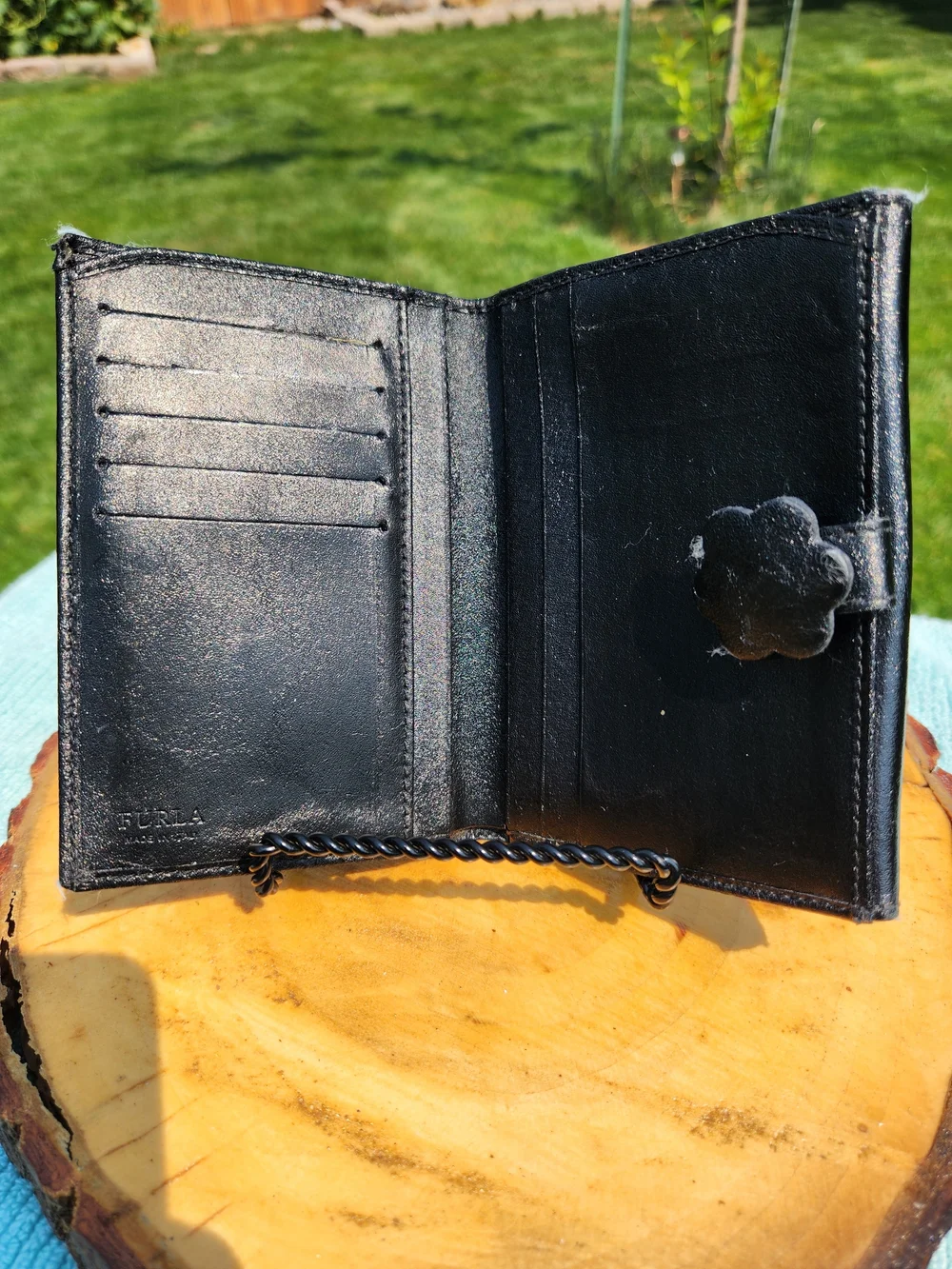 Authentic Furla trifold Compact wallet crafted from smooth black leather.
